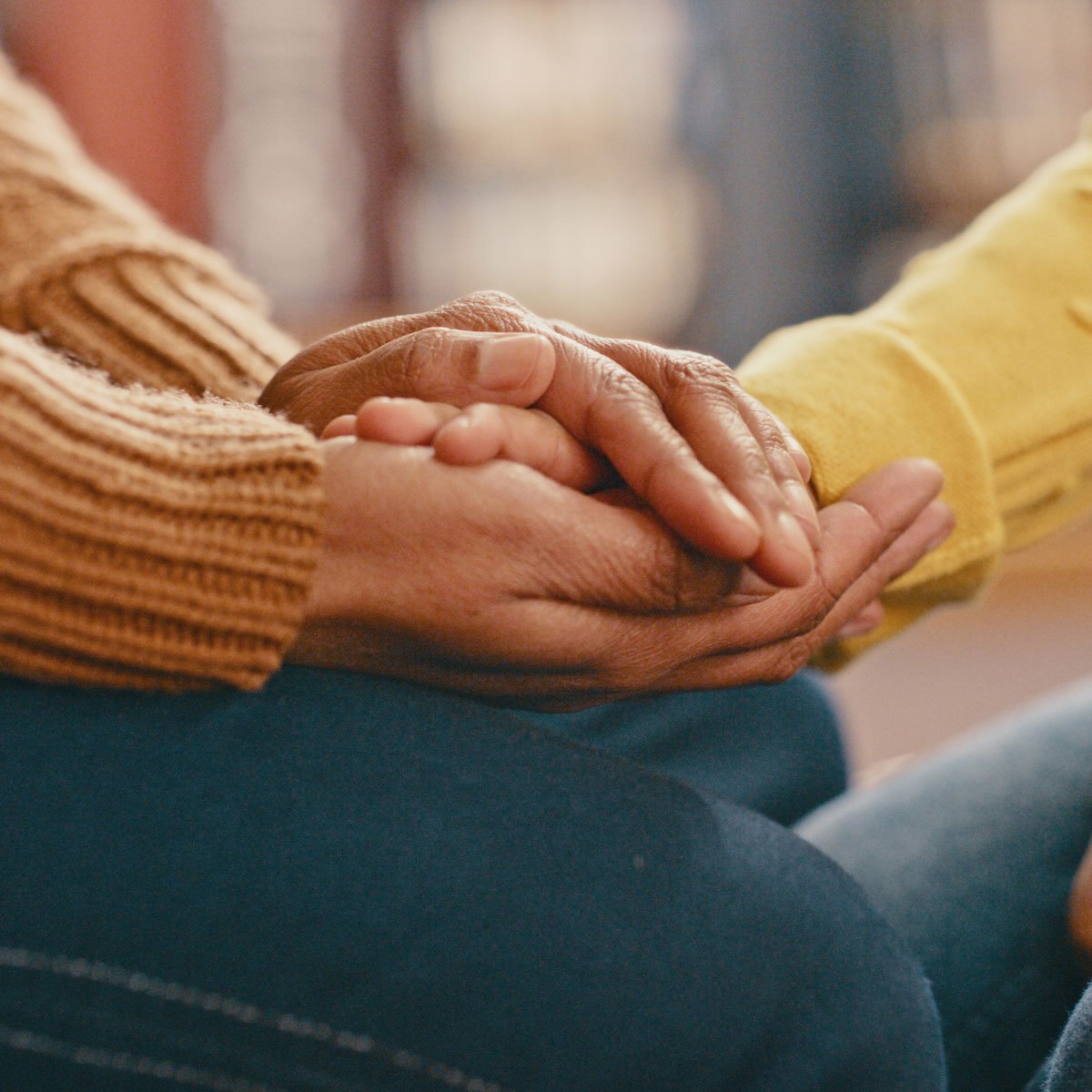 Carawell Counseling home page- two hands comforting the other person's hand